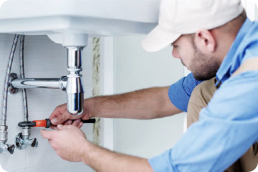 a plumber working under a sink